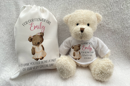 A beige teddy bear with a white t-shirt and a printed gift bag, both featuring personalized text as a thank you gift for a flower girl.